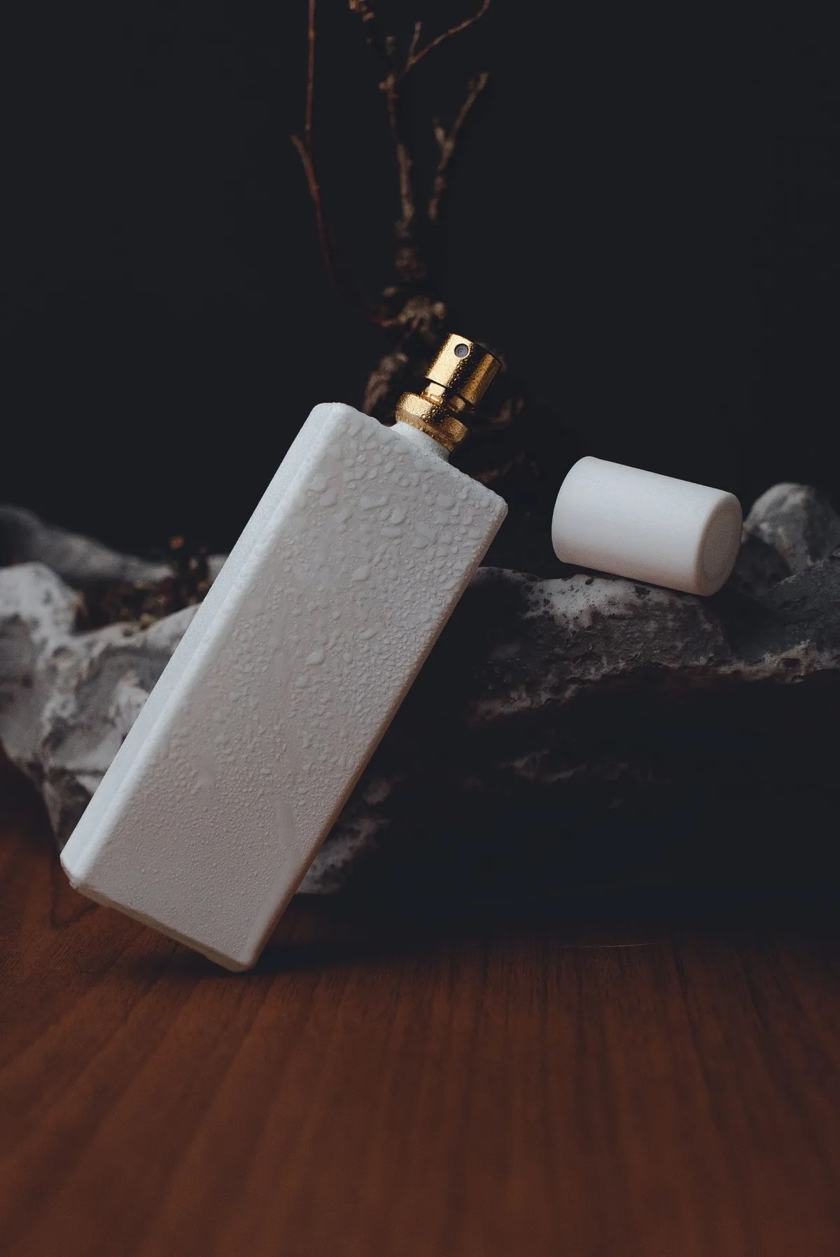 Original perfume bottle product photo on a dark styled set