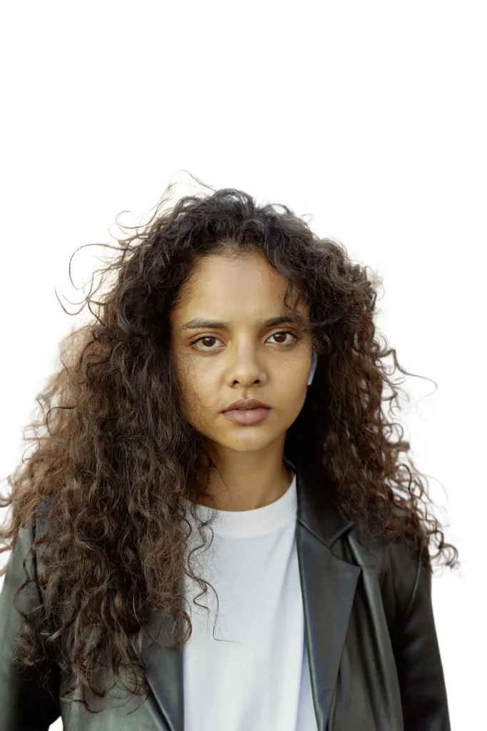 Portrait with curly hair on a clean white background after AI background removal