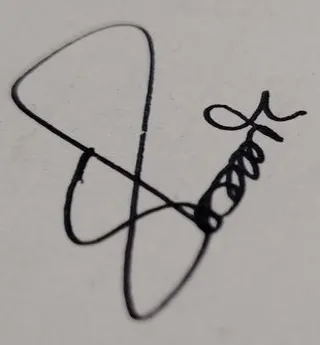 Original photo of a black pen signature on white paper